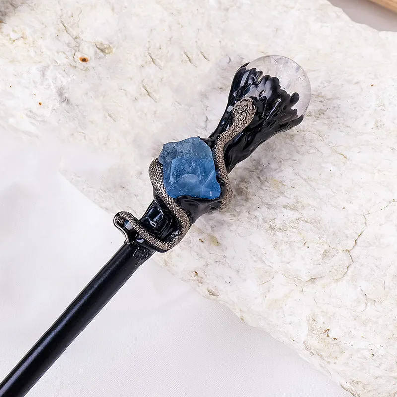 Natural crystal ball truncheon magic wand with amethyst stone ball on dark background