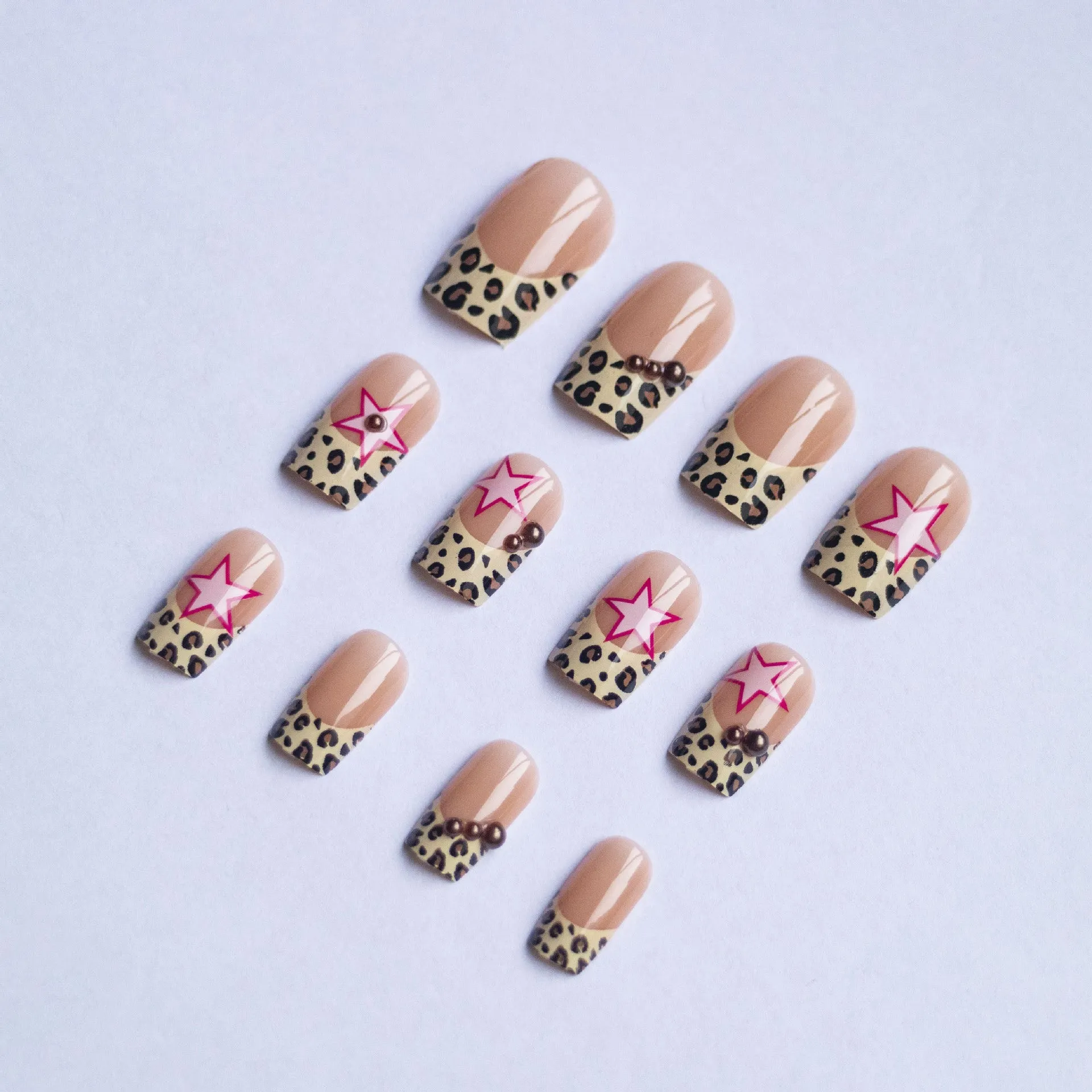 French manicure press on nails with leopard print pattern, star and pearl diamond accents