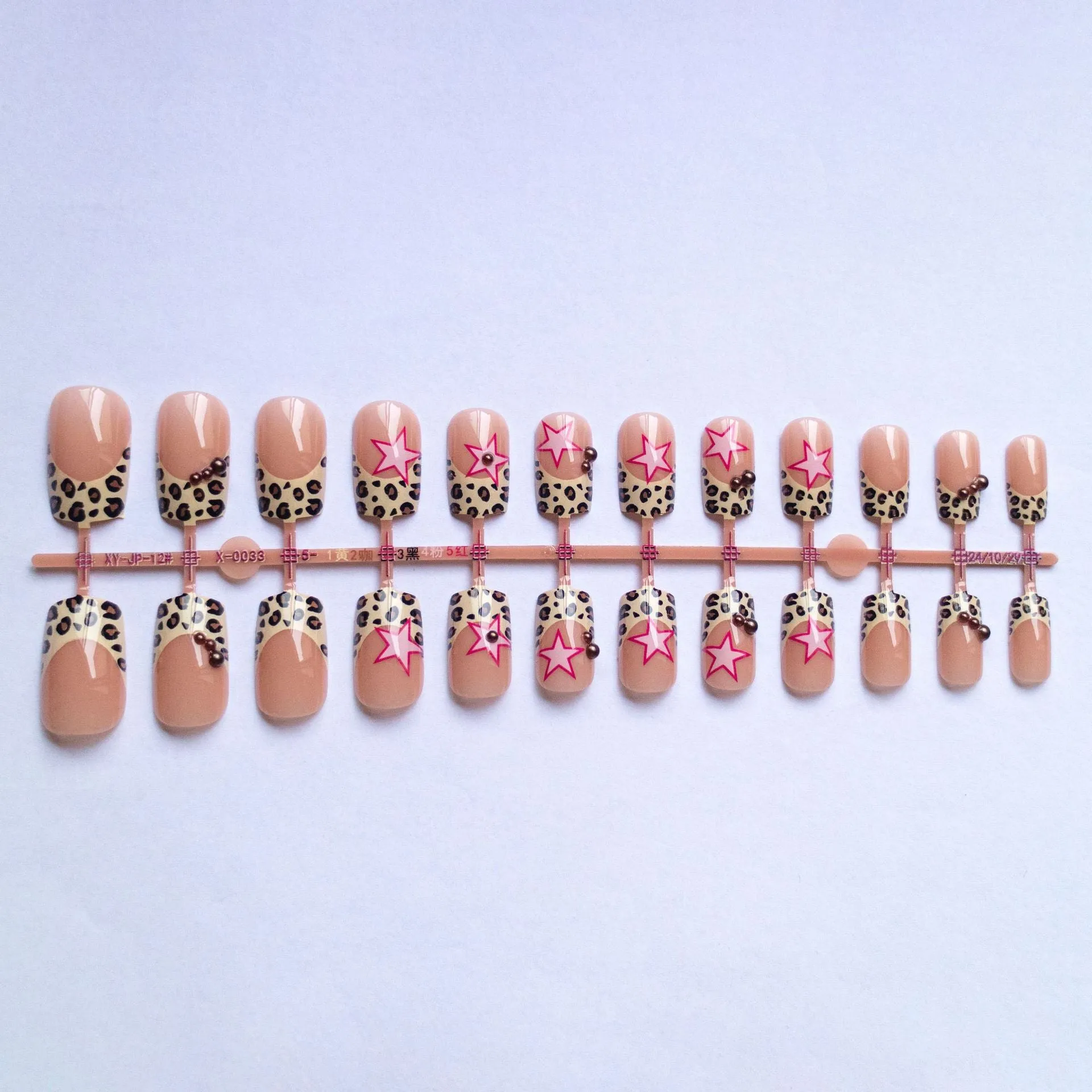 French manicure press on nails with leopard print pattern, star and pearl diamond accents