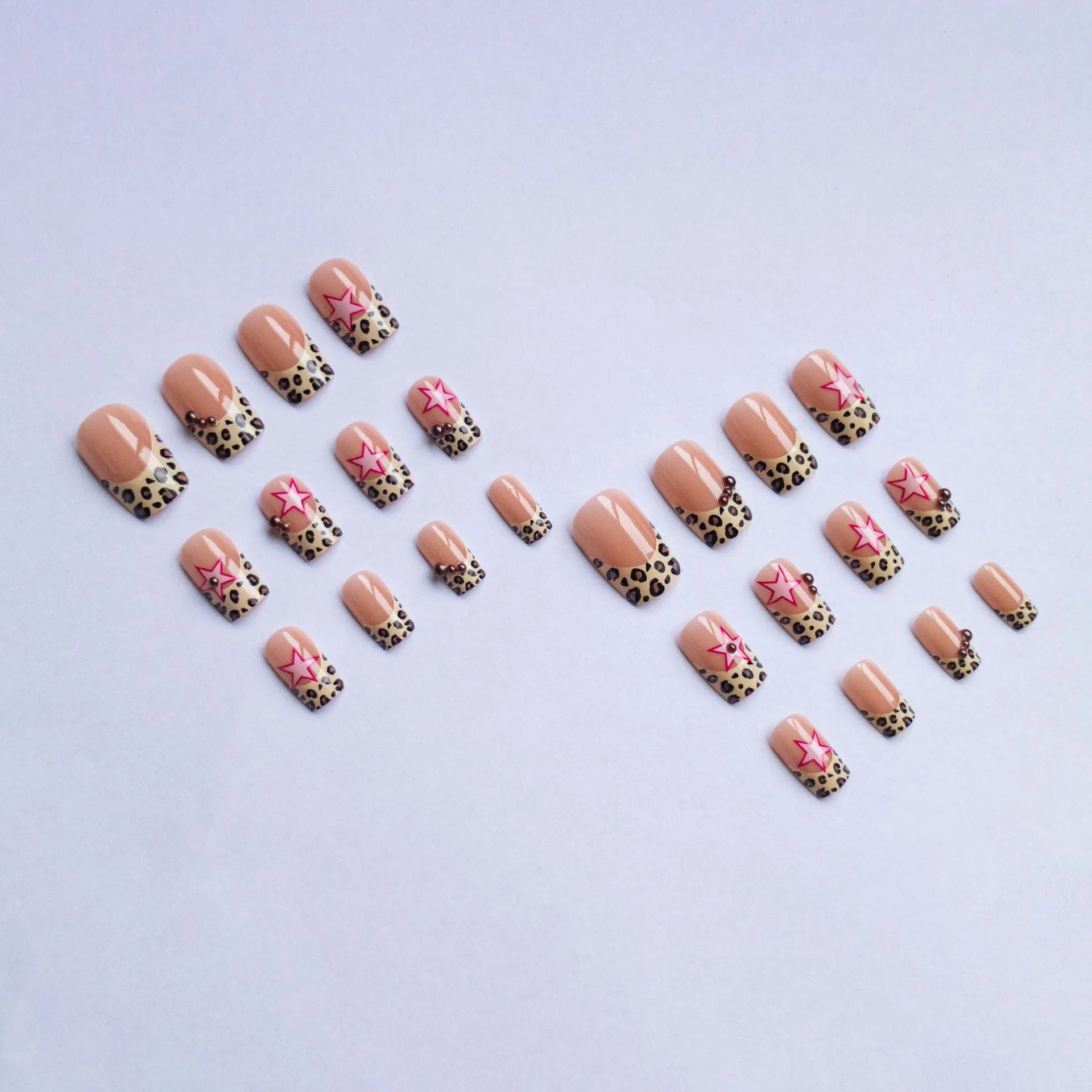 French manicure press on nails with leopard print pattern, star and pearl diamond accents