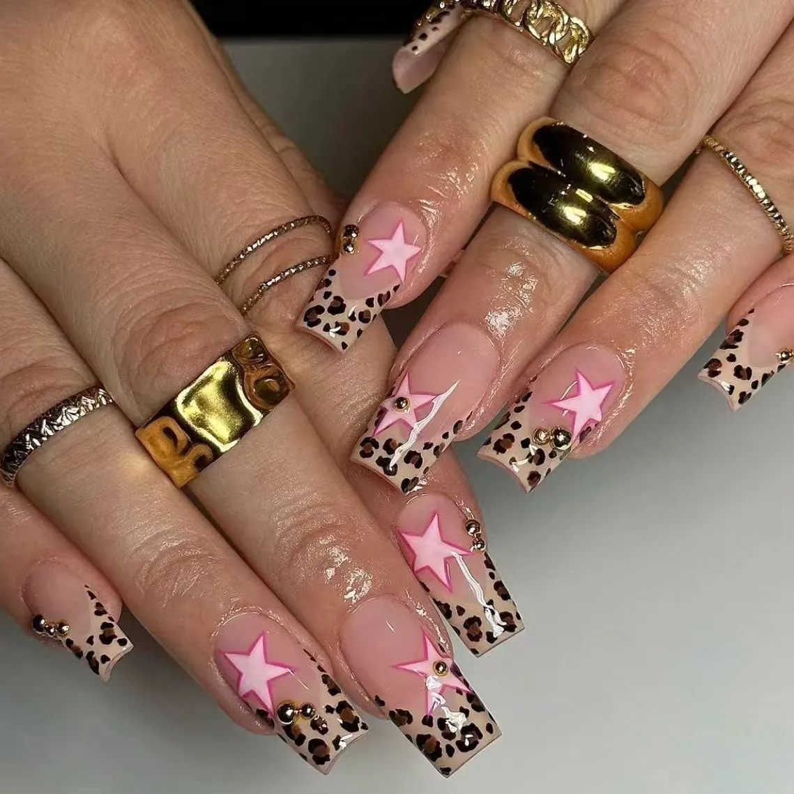 French manicure press on nails with leopard print pattern, star and pearl diamond accents