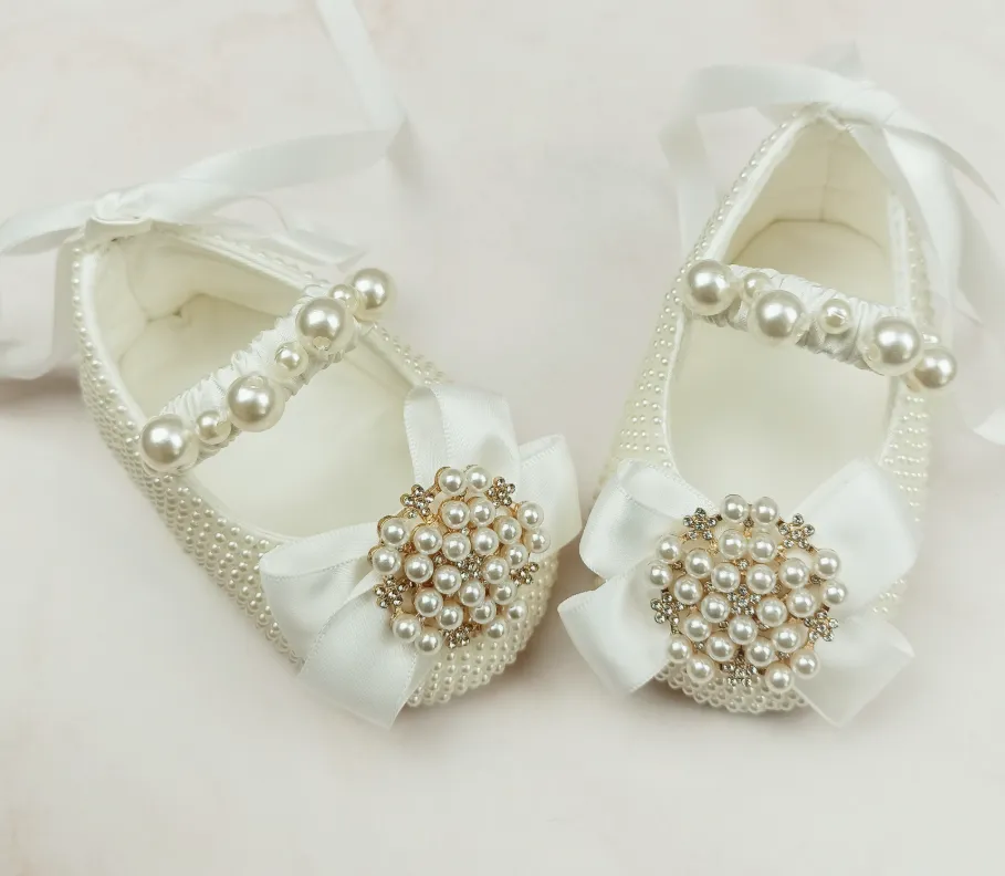 Milky white handmade soft sole cloth princess shoes with pearl detailing and lace-up closure for babies