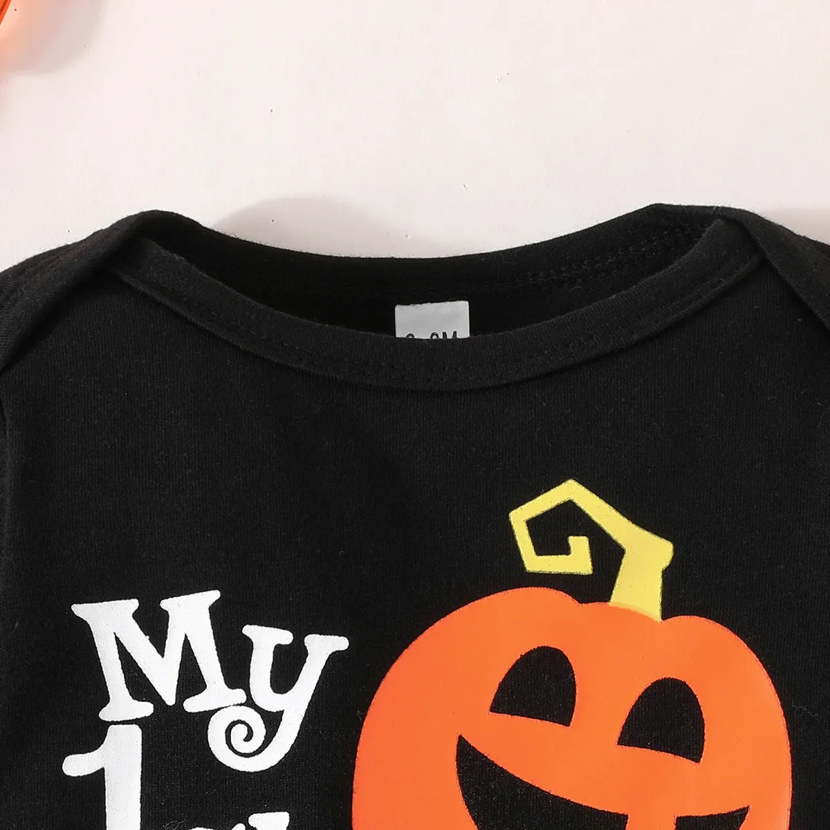 Baby Halloween letter print long-sleeve jumpsuit set with pumpkin trousers and removable hood hat on light background