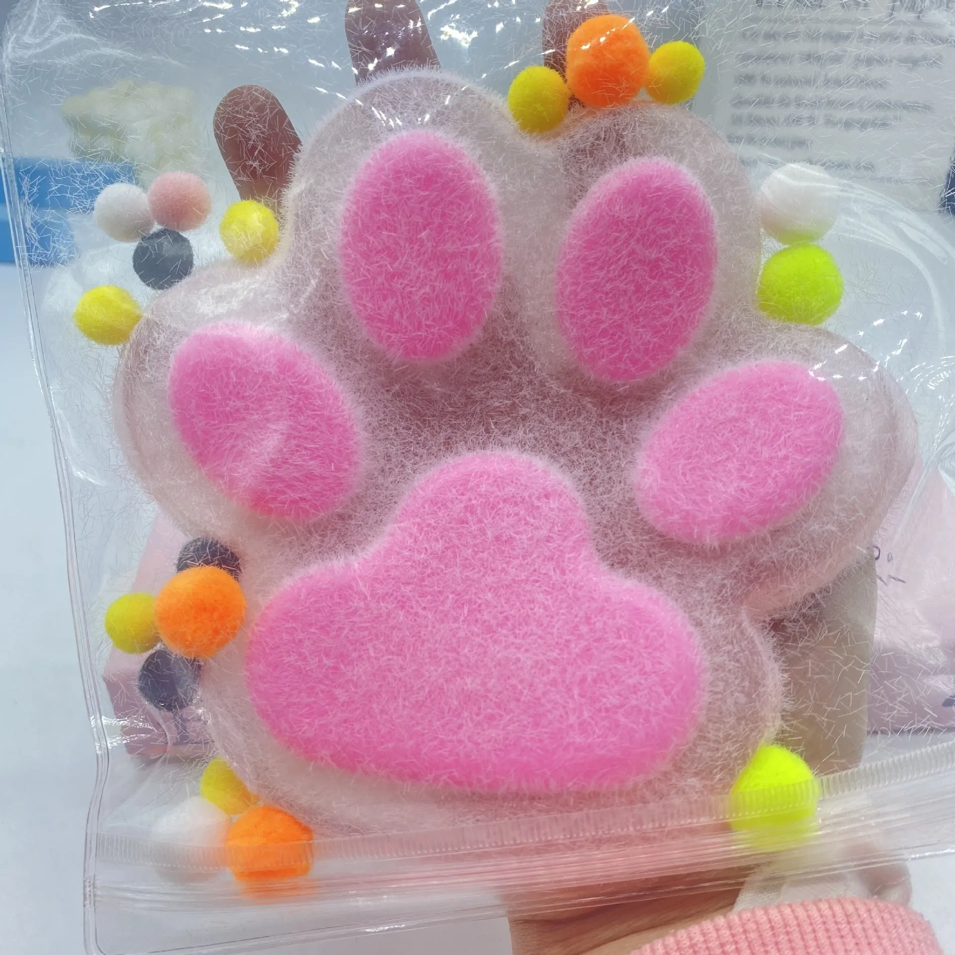 Oversized plush cat's paw squeezing toy in 14cm TPR flocking finish, black colour, on white background