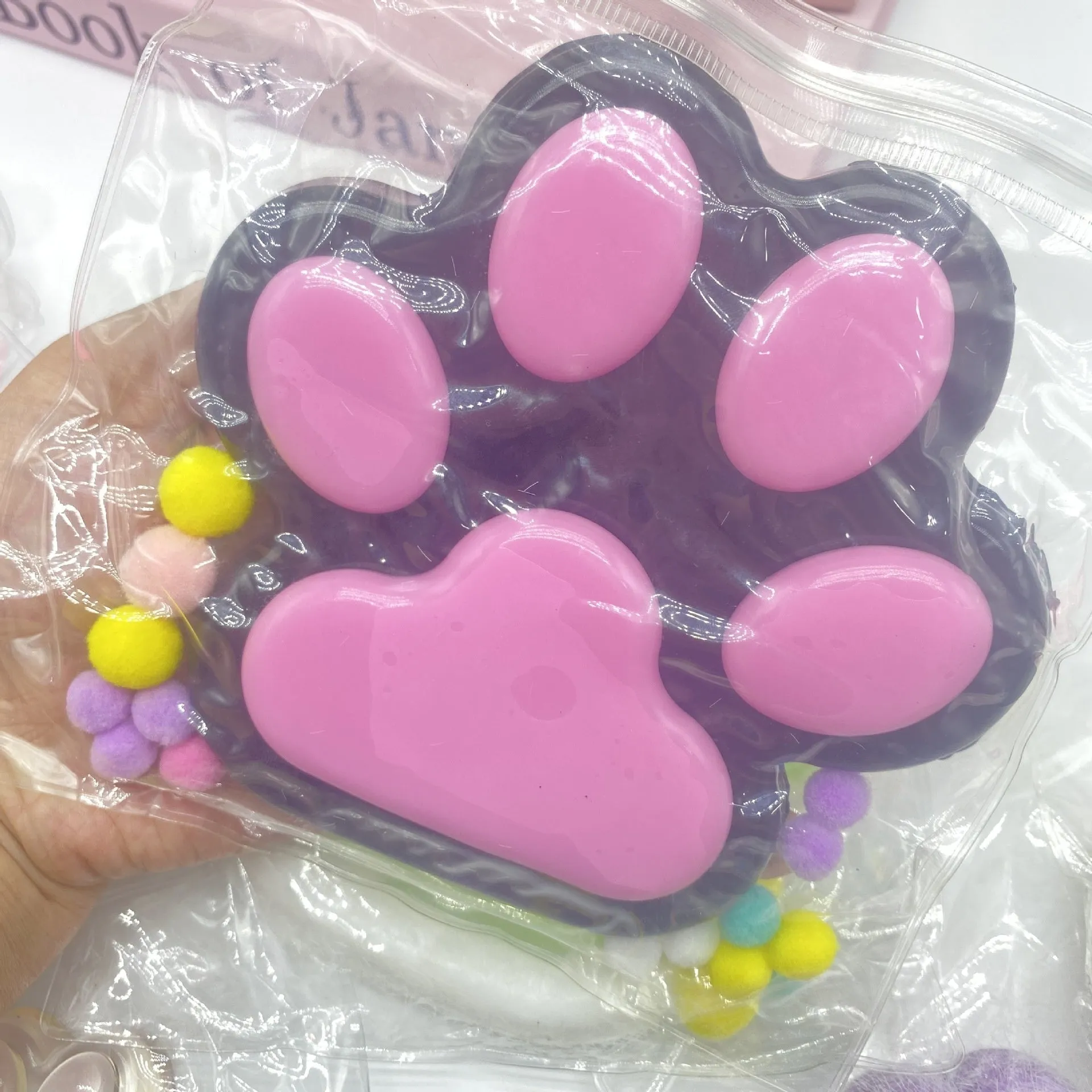 Oversized plush cat's paw squeezing toy in 14cm TPR flocking finish, black colour, on white background
