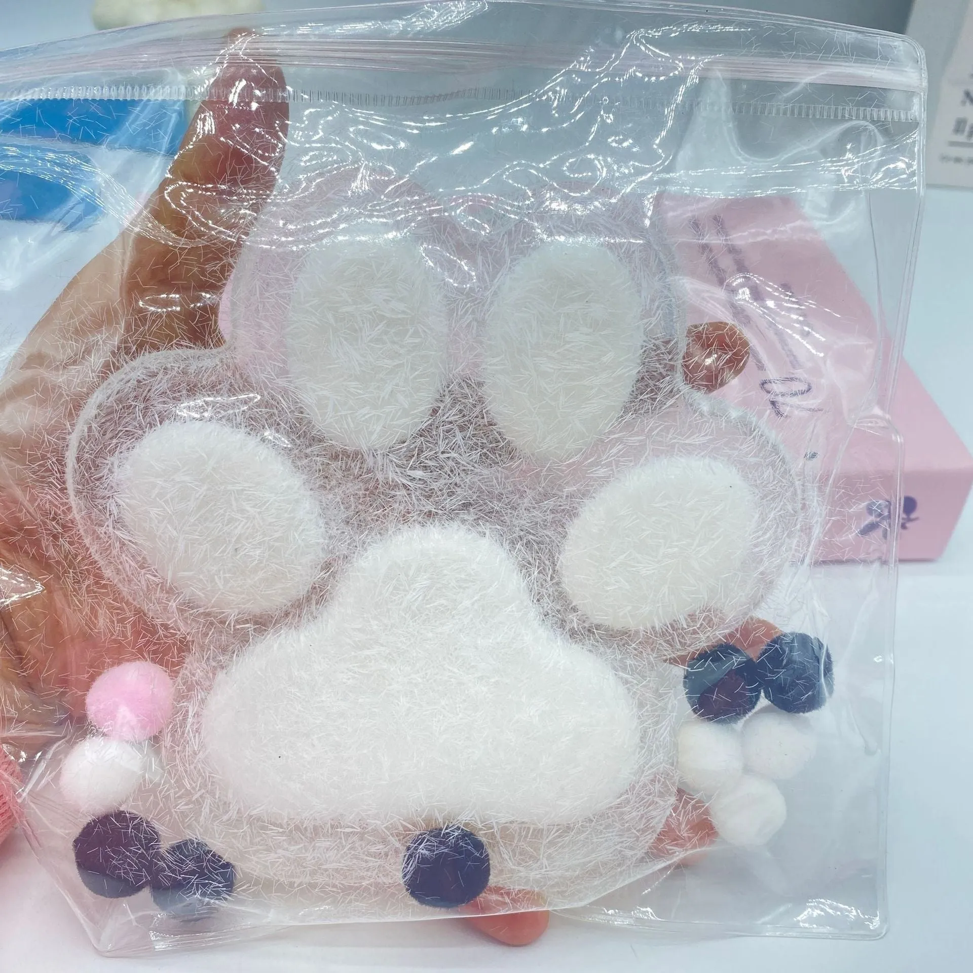 Oversized plush cat's paw squeezing toy in 14cm TPR flocking finish, black colour, on white background