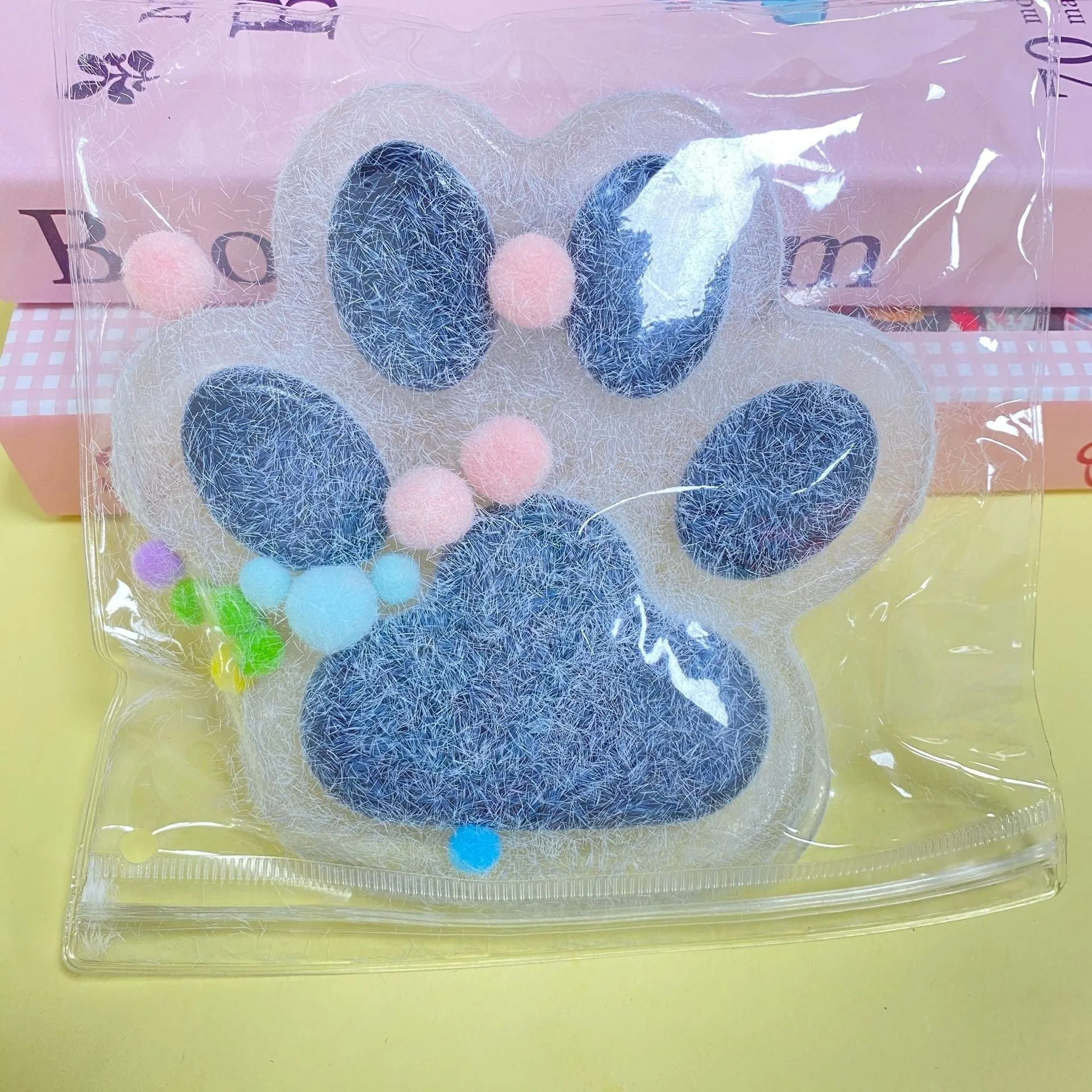 Oversized plush cat's paw squeezing toy in 14cm TPR flocking finish, black colour, on white background