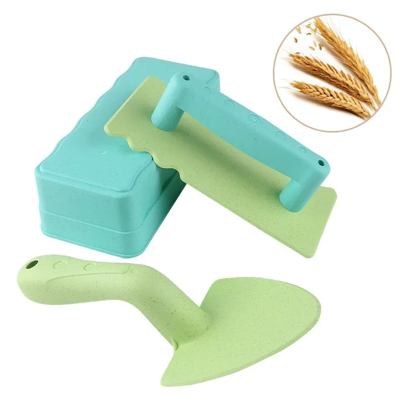 Wheat straw sand shovel brick toy in brown, 19 cm long, on sand with blurred background