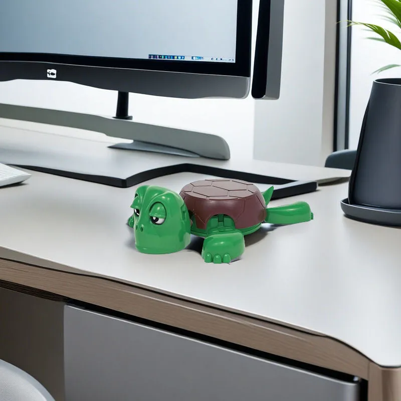 ABS plastic turtle coaster in green shape on desk with a glass of water nearby