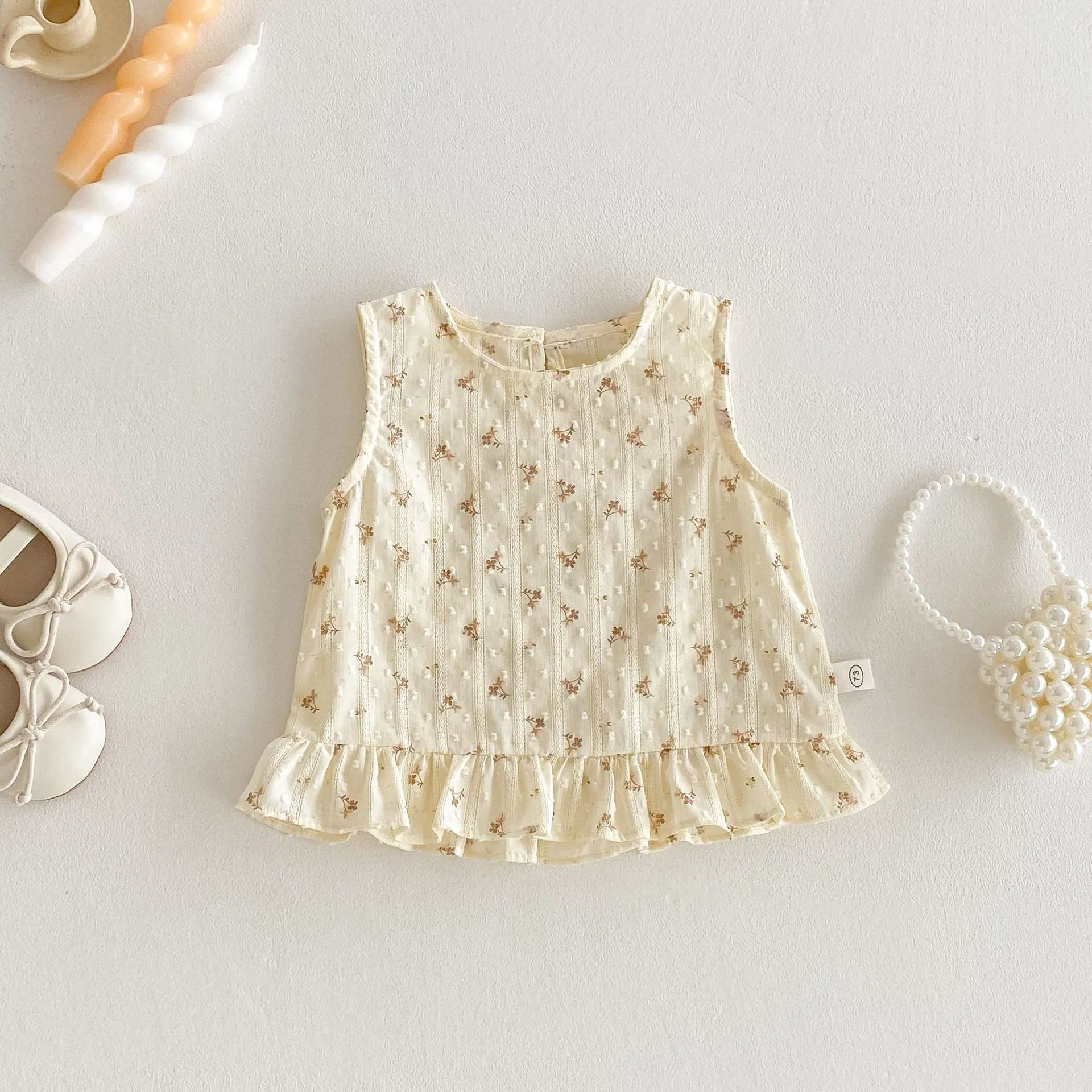 Children's cotton sleeveless top and trousers two-piece set in cream apricot on white background