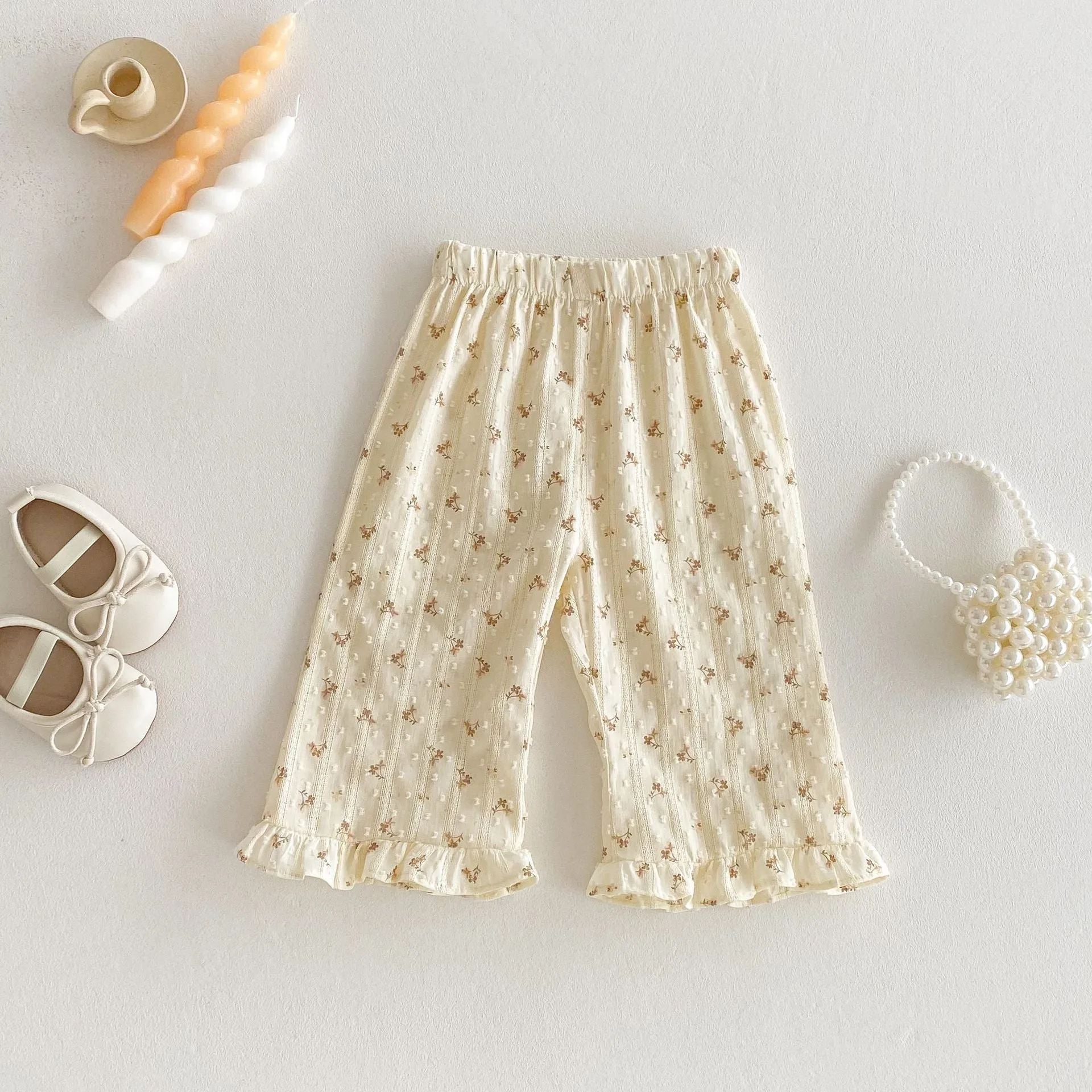 Children's cotton sleeveless top and trousers two-piece set in cream apricot on white background