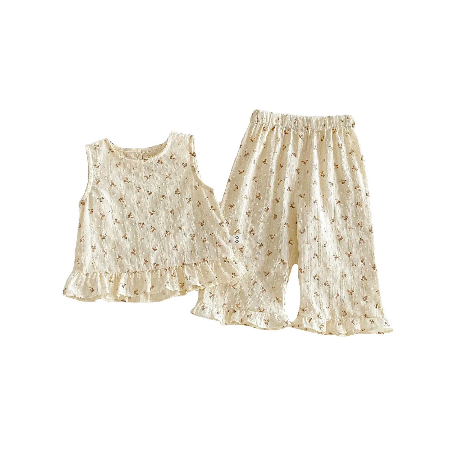 Children's cotton sleeveless top and trousers two-piece set in cream apricot on white background