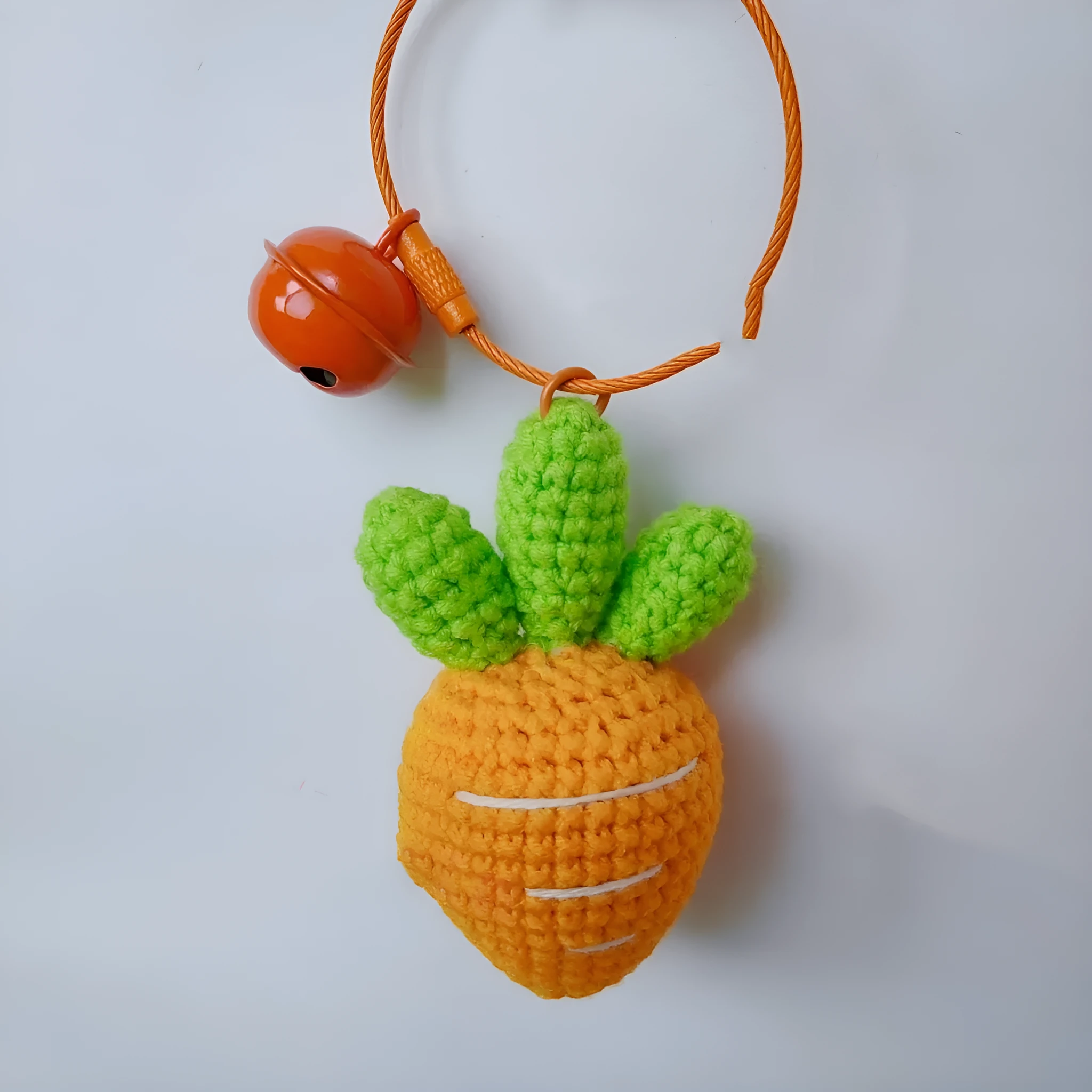 Wool cartoon carrot-shaped keychain pendant on a key ring.