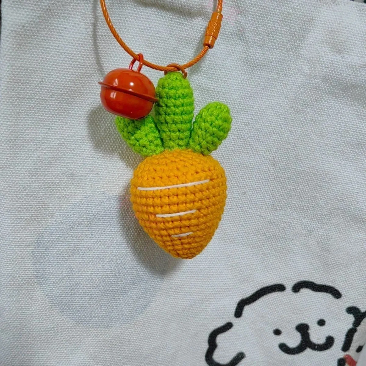 Wool cartoon carrot-shaped keychain pendant on a key ring.