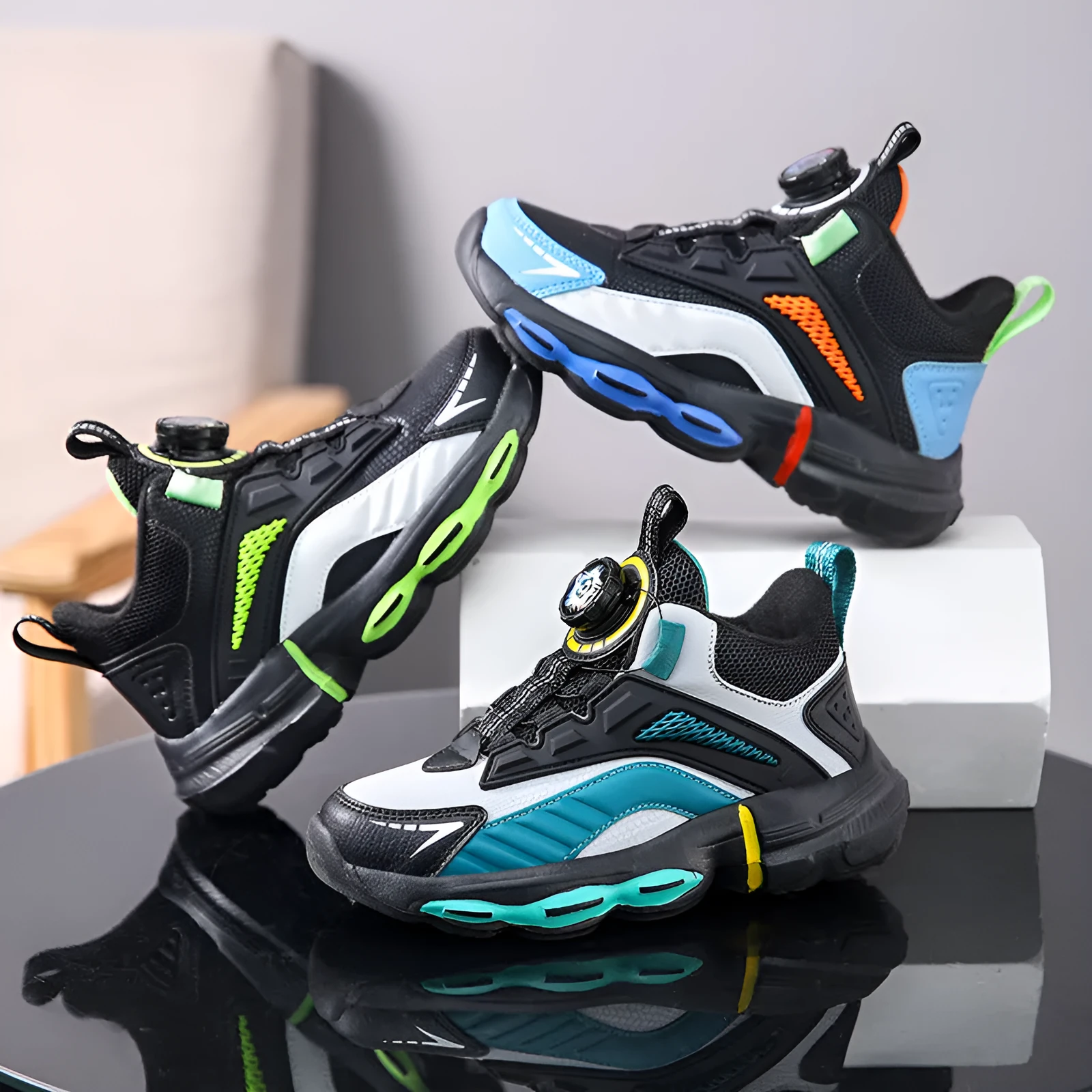 Children's waterproof leather basketball shoes with rotating buckle, black and grey colour, on natural lawn