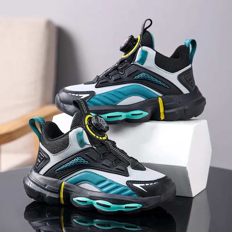 Children's waterproof leather basketball shoes with rotating buckle, black and grey colour, on natural lawn