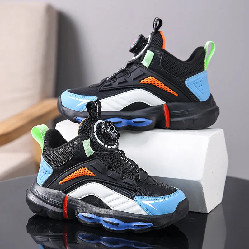 Children's waterproof leather basketball shoes with rotating buckle, black and grey colour, on natural lawn