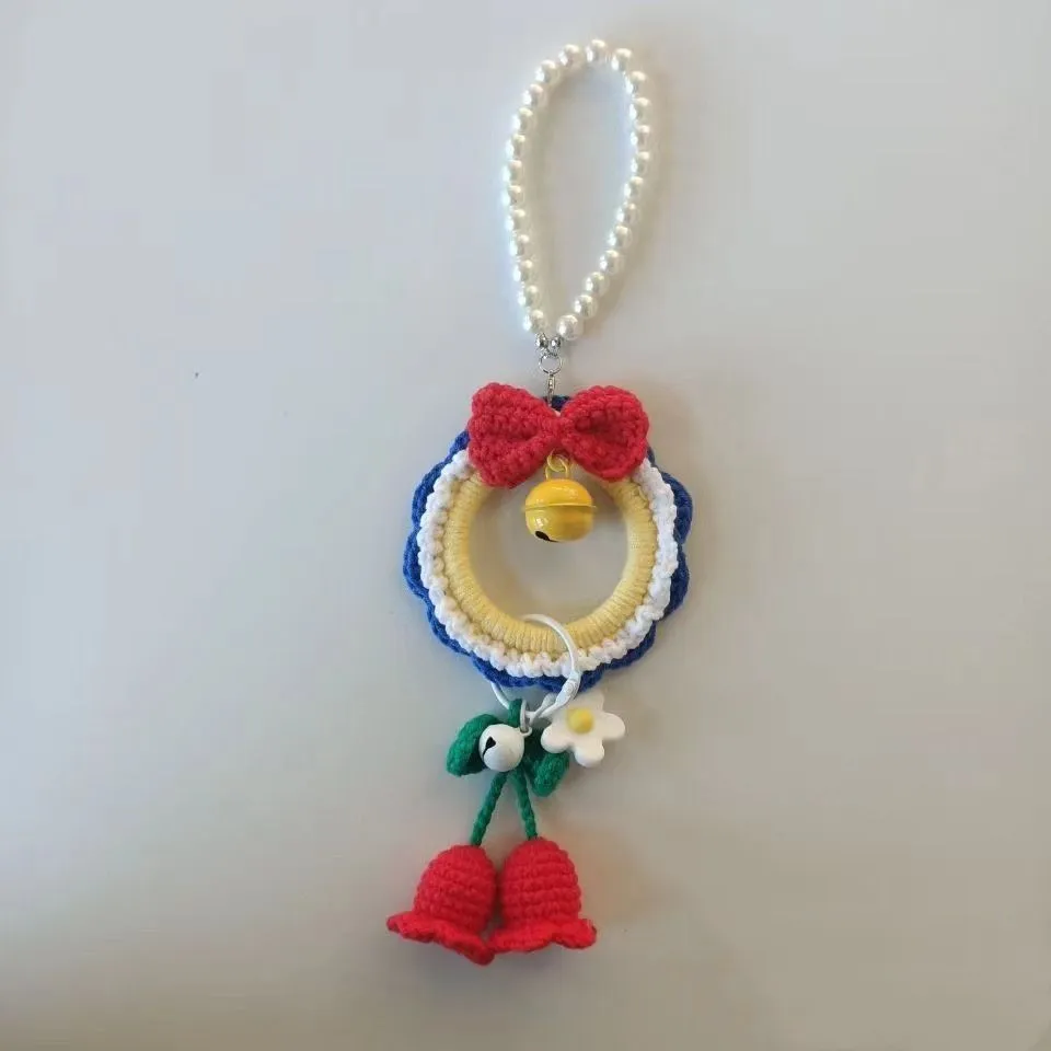 Handmade plush yarn Snow White character car hanging ornament on a clear background.