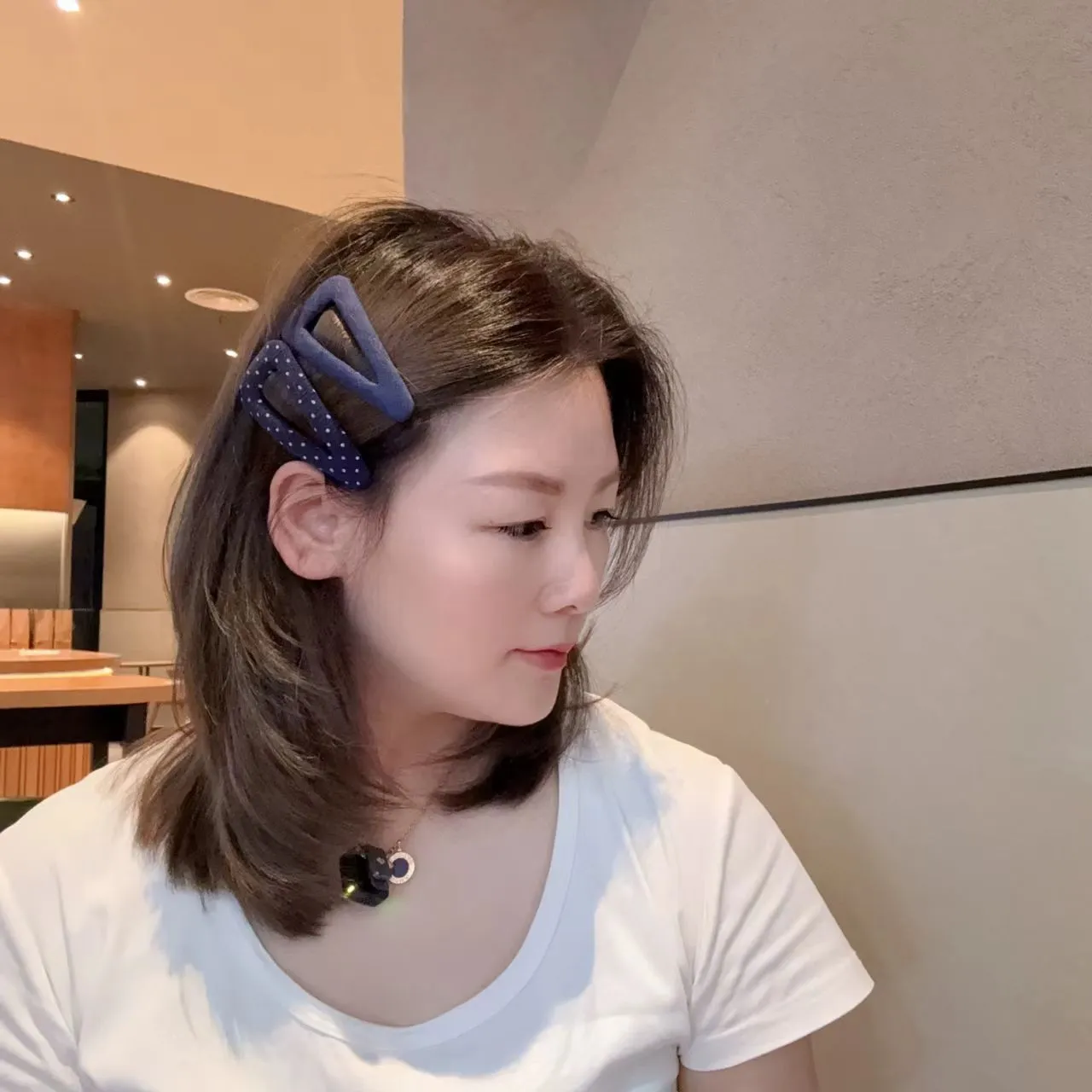 French retro style hair barrettes in triangle and water drop shapes with dark denim and polka dot patterns.