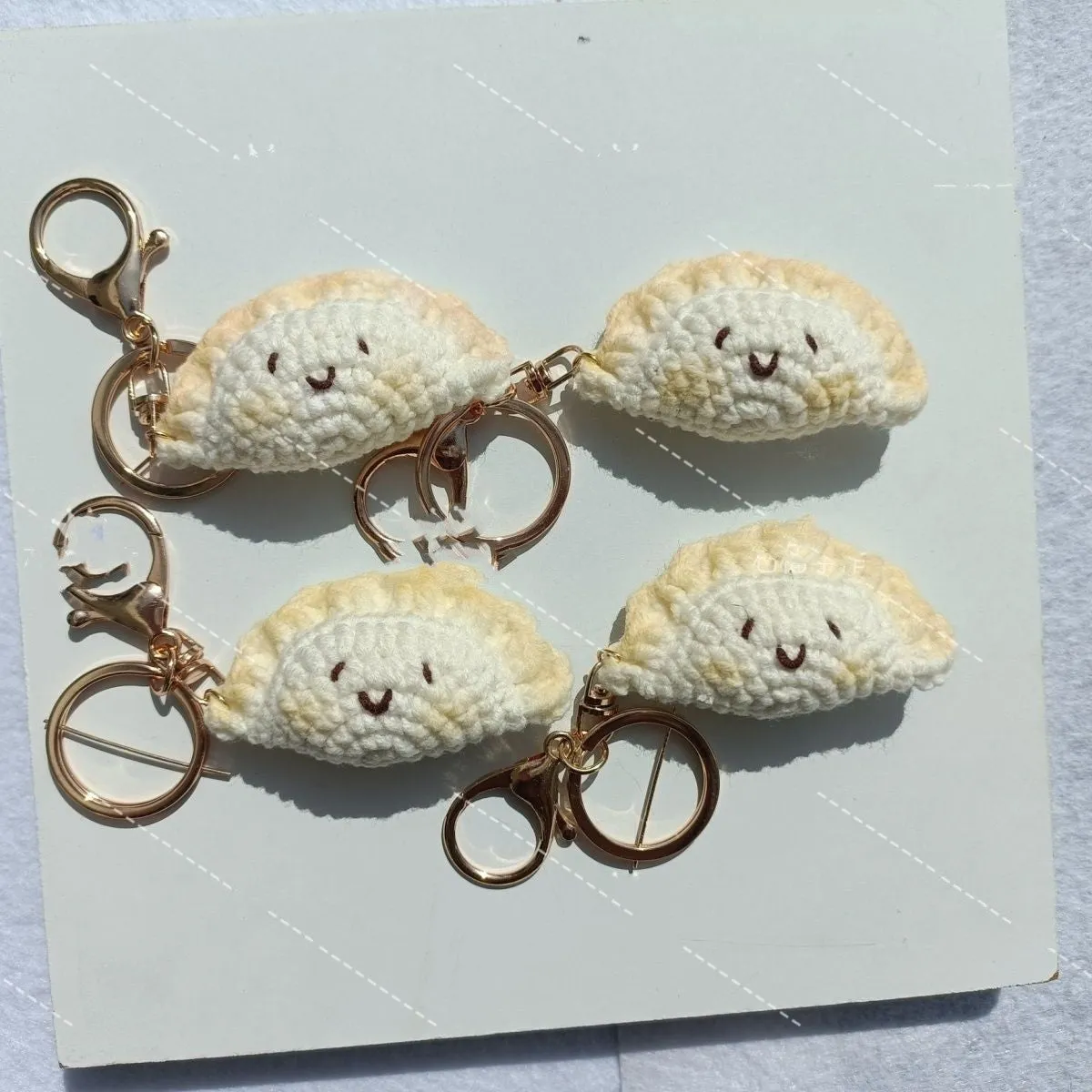 Handmade crochet plush dumpling pendant with keychain in traditional Spring Festival design.