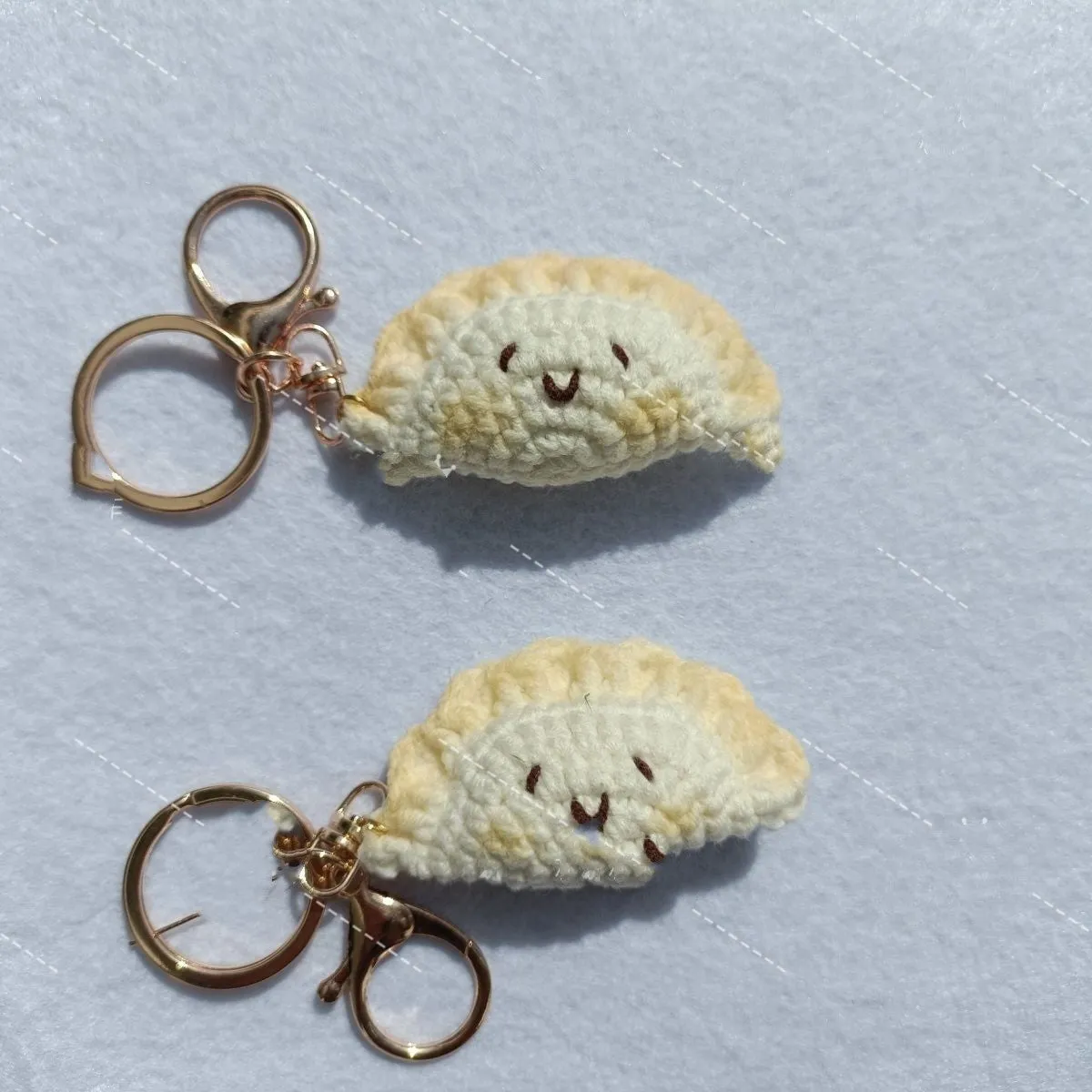 Handmade crochet plush dumpling pendant with keychain in traditional Spring Festival design.