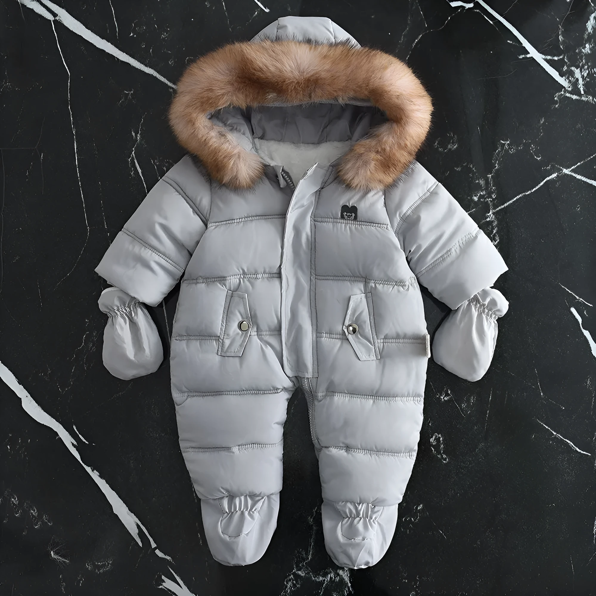 Fleece-lined thick hooded baby jumpsuit in beige with zip front and fur hood