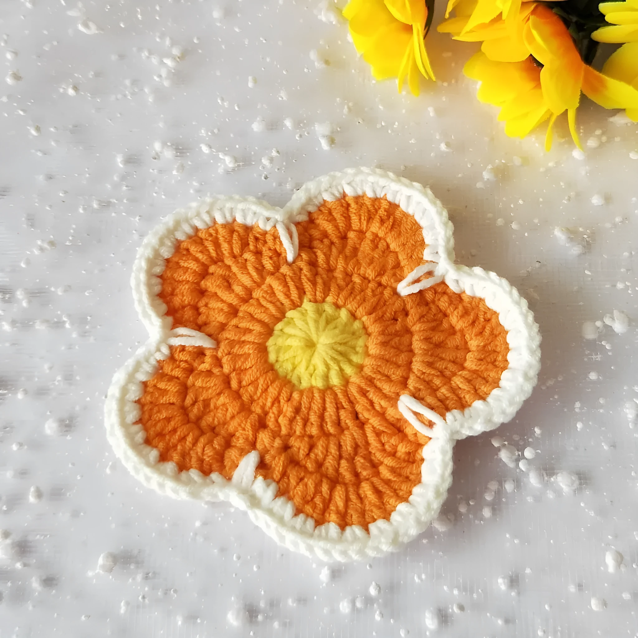 Set of five handmade woven cotton thread flower placemats in blue, green, orange, pink, and purple.