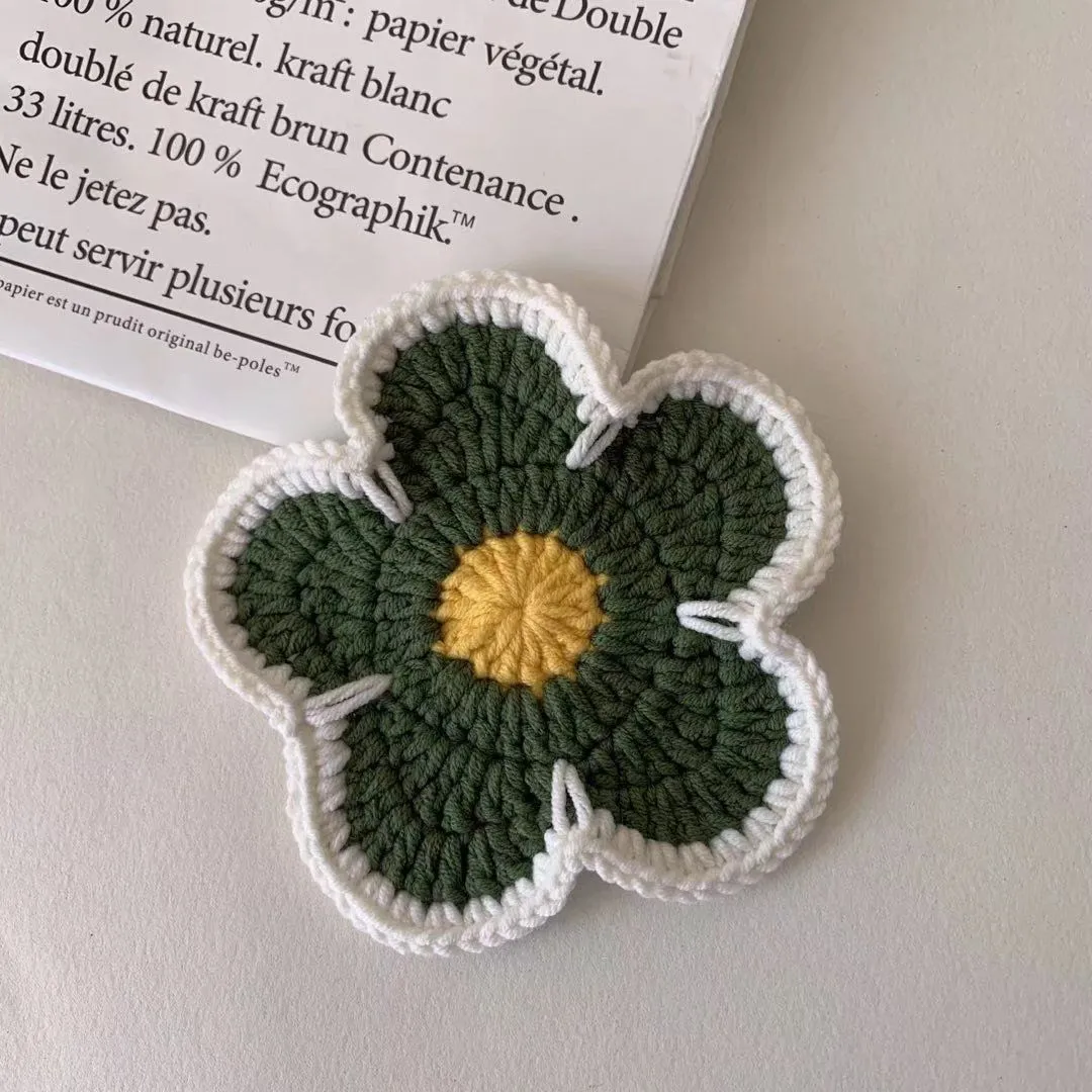 Set of five handmade woven cotton thread flower placemats in blue, green, orange, pink, and purple.