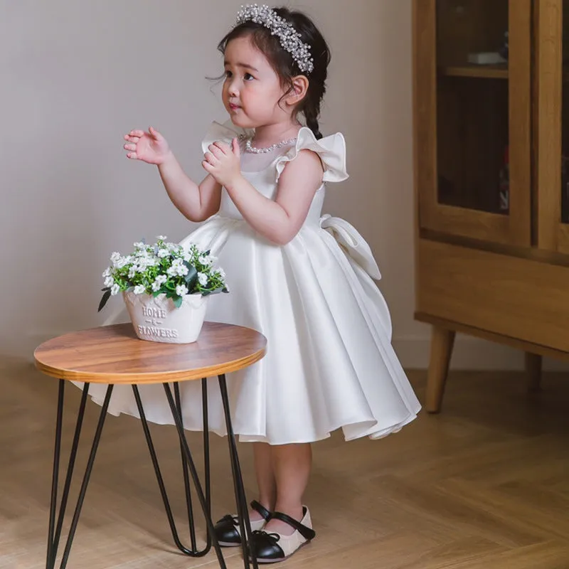 Girls' white satin princess dress with puff sleeves, full-length view, white fabric
