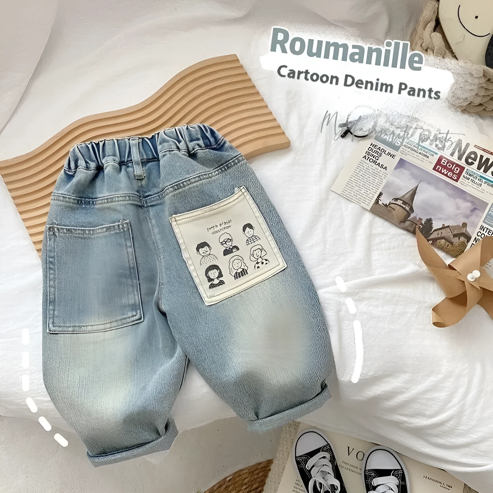 Light-coloured boys denim jeans with printed back pocket and elastic waist, front view