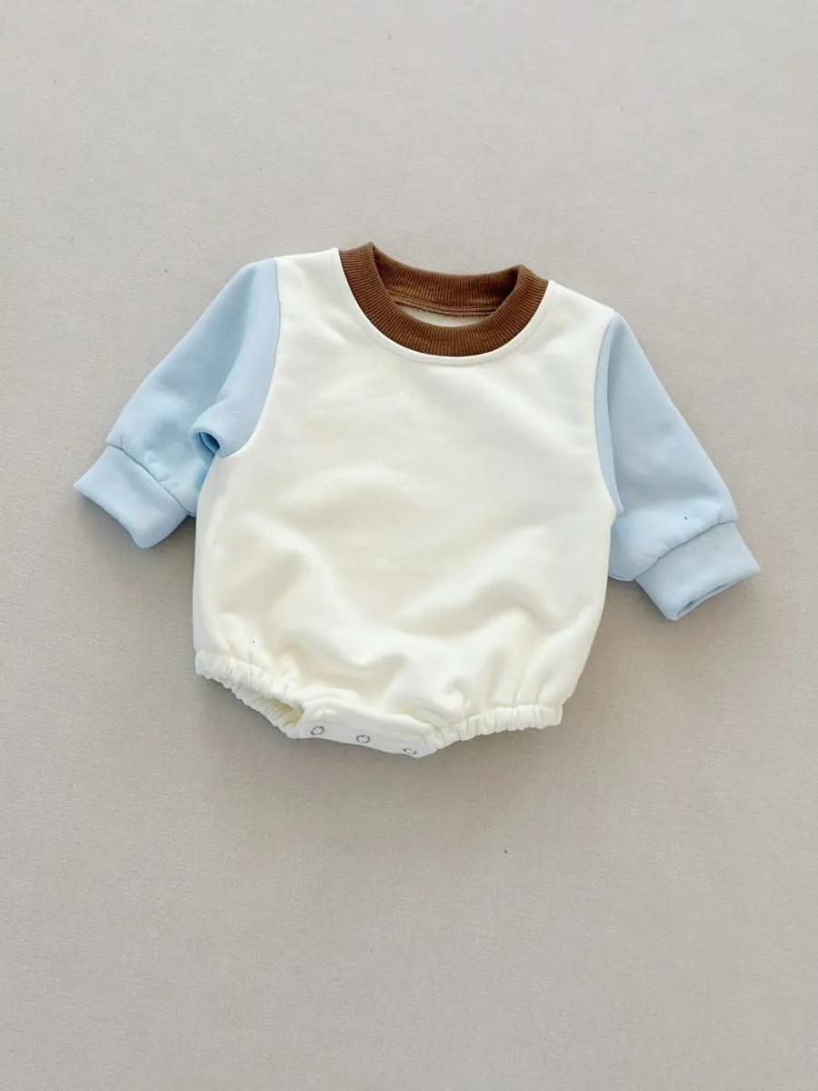 Baby romper in cotton triangle jumpsuit style with hidden hook closure, autumn weight, available in multiple colours