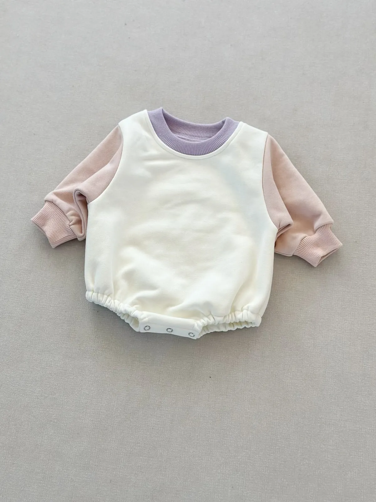 Baby romper in cotton triangle jumpsuit style with hidden hook closure, autumn weight, available in multiple colours