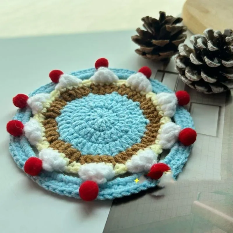 Handmade round wool coaster bag for hot mugs on a table