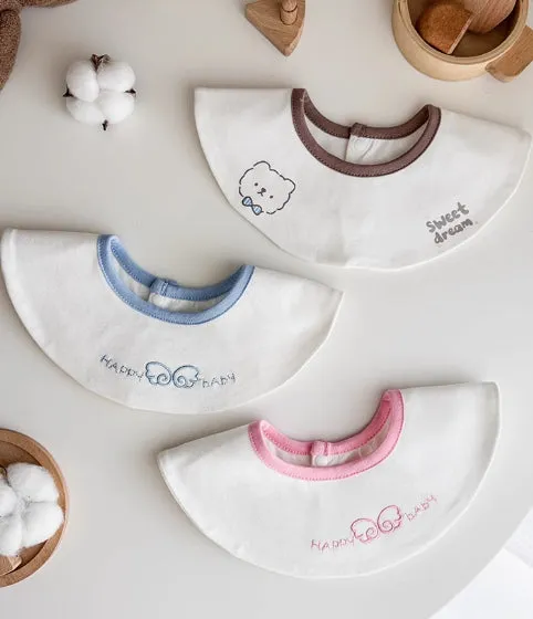 Set of three small cotton baby bibs in assorted colours with waterproof layer for milk spill protection