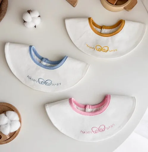 Set of three small cotton baby bibs in assorted colours with waterproof layer for milk spill protection