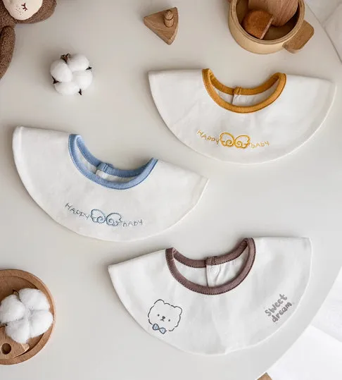 Set of three small cotton baby bibs in assorted colours with waterproof layer for milk spill protection