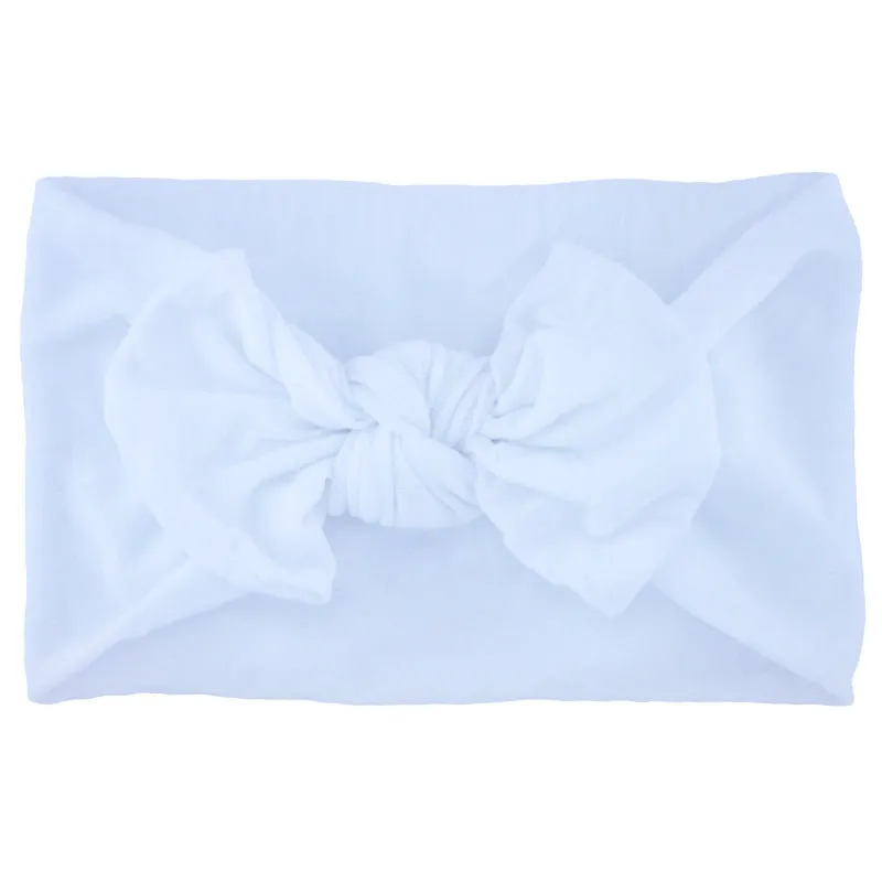 Super stretchy soft knot headband with hair bow for baby girls in one of 22 colours
