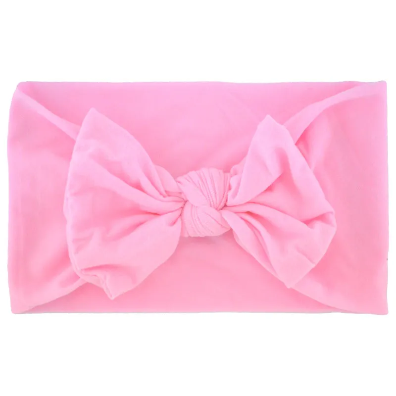 Super stretchy soft knot headband with hair bow for baby girls in one of 22 colours