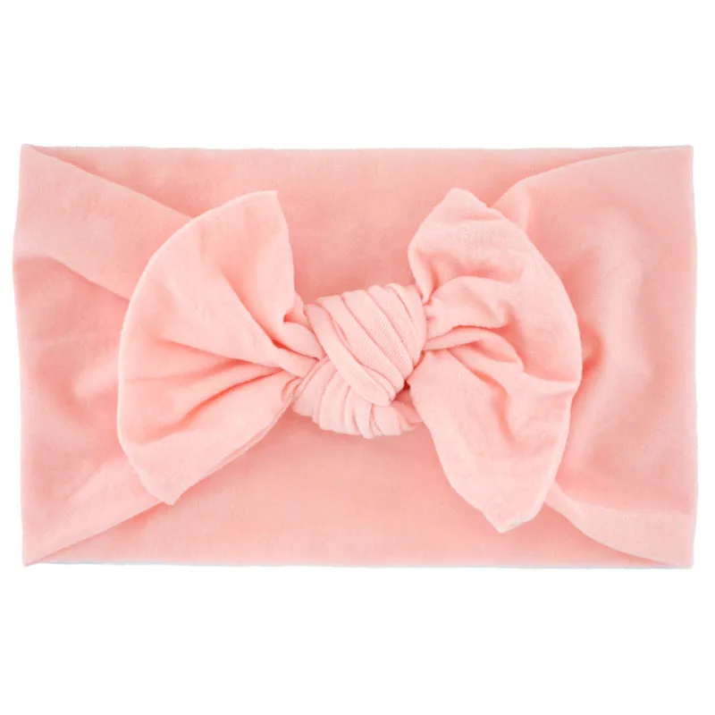 Super stretchy soft knot headband with hair bow for baby girls in one of 22 colours