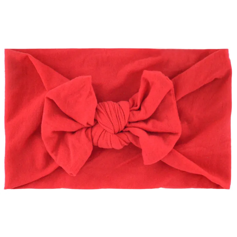 Super stretchy soft knot headband with hair bow for baby girls in one of 22 colours