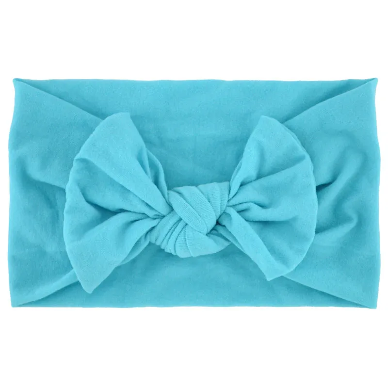 Super stretchy soft knot headband with hair bow for baby girls in one of 22 colours