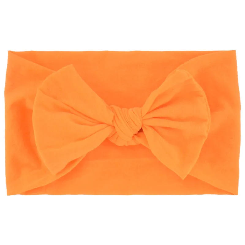 Super stretchy soft knot headband with hair bow for baby girls in one of 22 colours