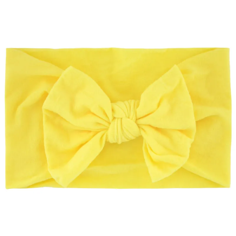 Super stretchy soft knot headband with hair bow for baby girls in one of 22 colours