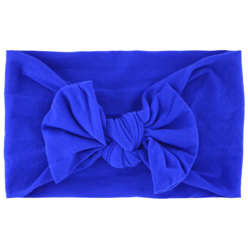 Super stretchy soft knot headband with hair bow for baby girls in one of 22 colours