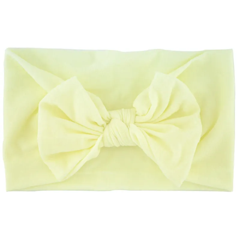 Super stretchy soft knot headband with hair bow for baby girls in one of 22 colours