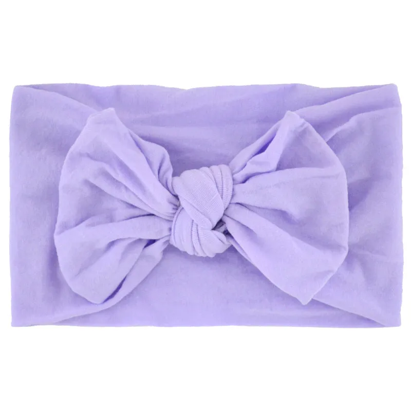 Super stretchy soft knot headband with hair bow for baby girls in one of 22 colours