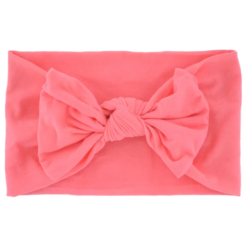 Super stretchy soft knot headband with hair bow for baby girls in one of 22 colours