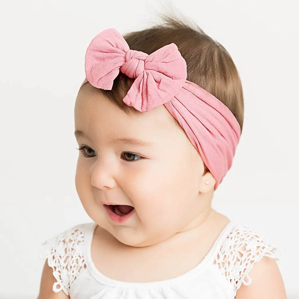 Super stretchy soft knot headband with hair bow for baby girls in one of 22 colours