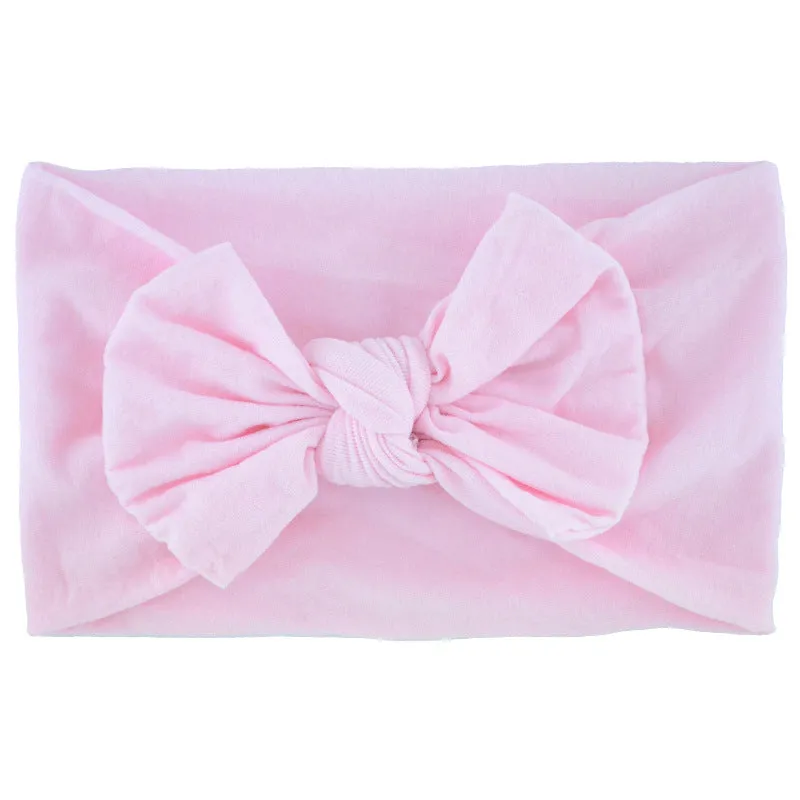 Super stretchy soft knot headband with hair bow for baby girls in one of 22 colours
