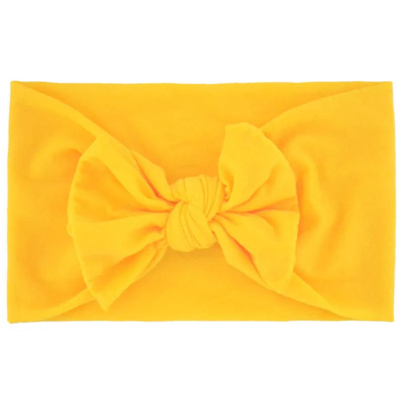 Super stretchy soft knot headband with hair bow for baby girls in one of 22 colours